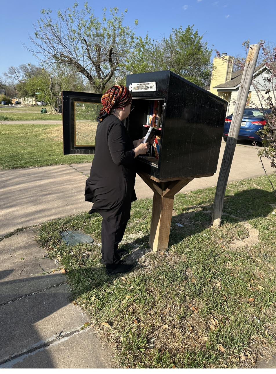 A little free library being restocked with donated books in Central Texas